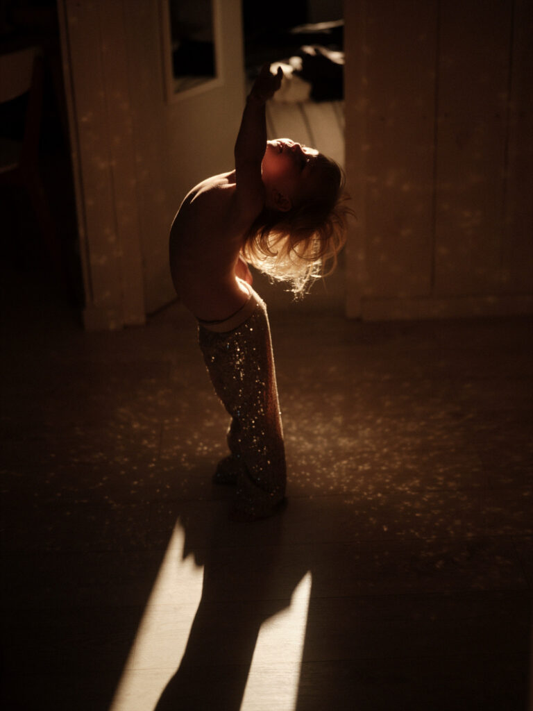 A child standing in low sun casting a long shadow