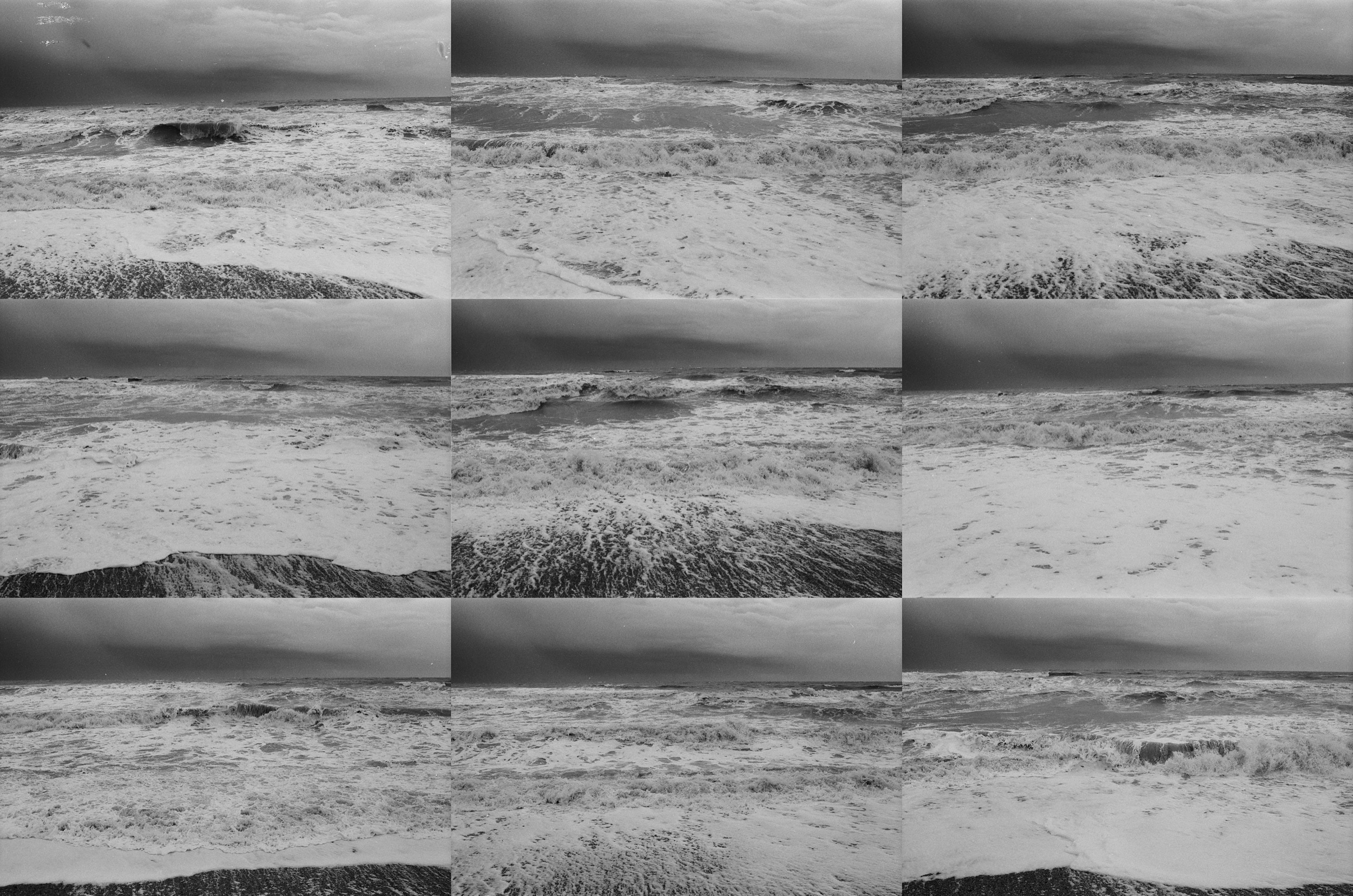 Nine black-and-white photographs of breaking waves beneath a dark, cloudy sky, arranged in a three-by-three grid.
